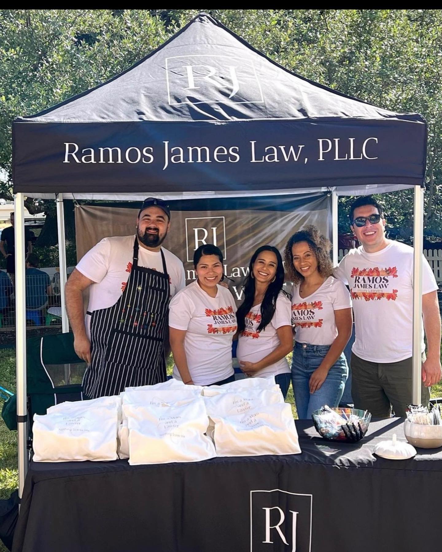 ramos James law team with signage during fair